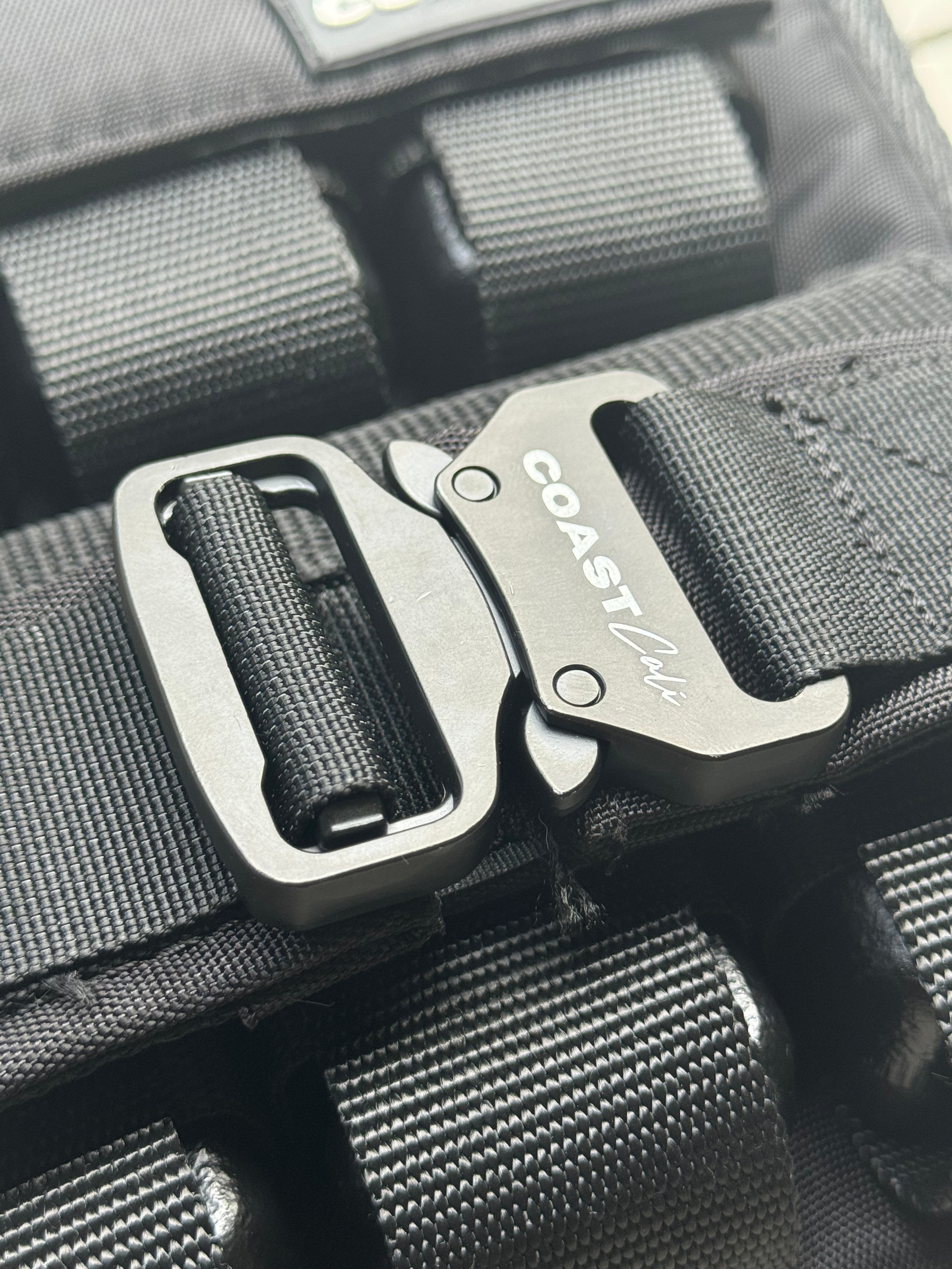 Close-up of a black weight vest with a Coast Cali brand buckle.