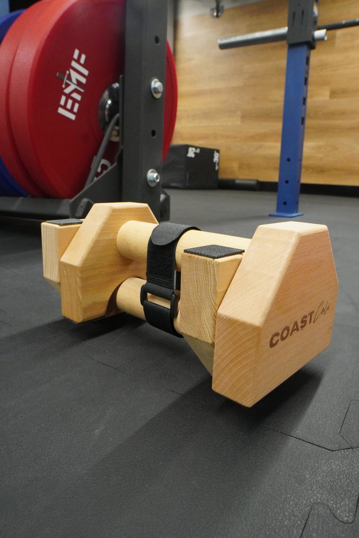 A pair of wooden travel parallettes in the gym
