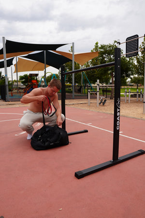 Man packing away some resistance bands into a bag