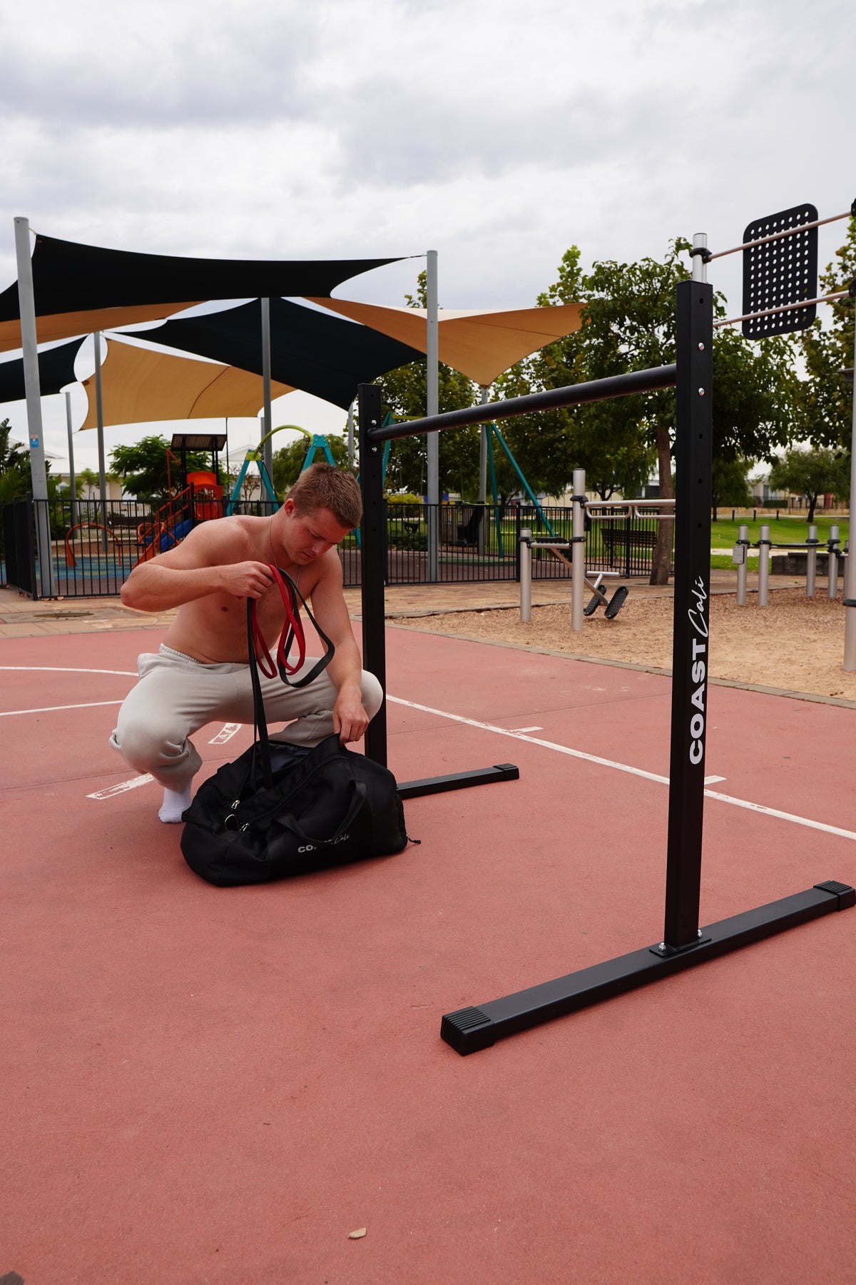 Man packing away some resistance bands into a bag