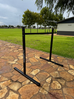 A black static bar used for calisthenics with Coast Cali logo on the vertical support.