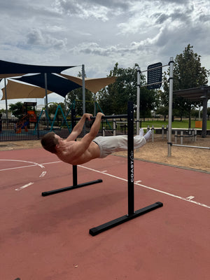 A man doing a front lever on a calisthenics static bar.
