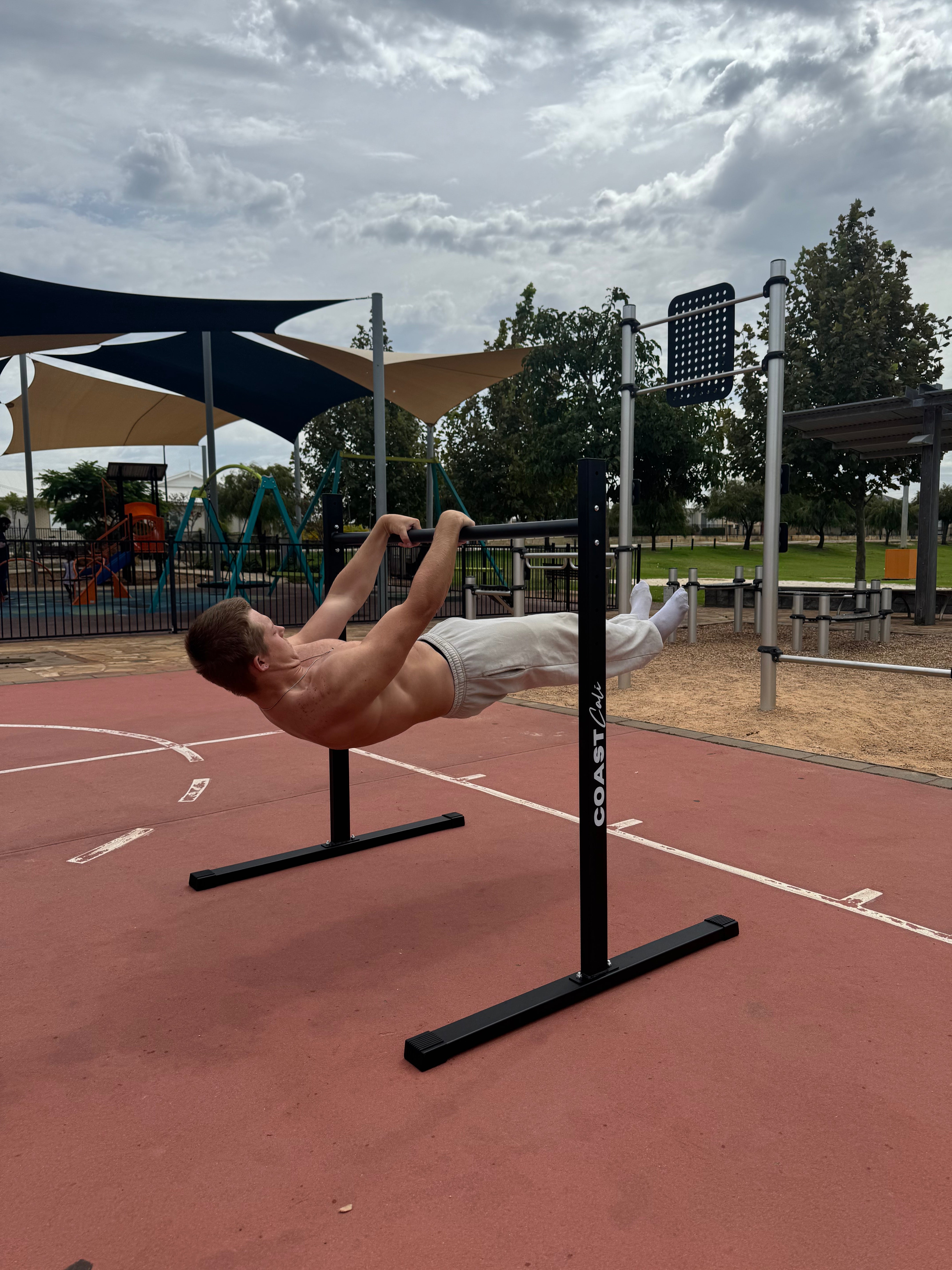 A man doing a front lever on a calisthenics static bar.