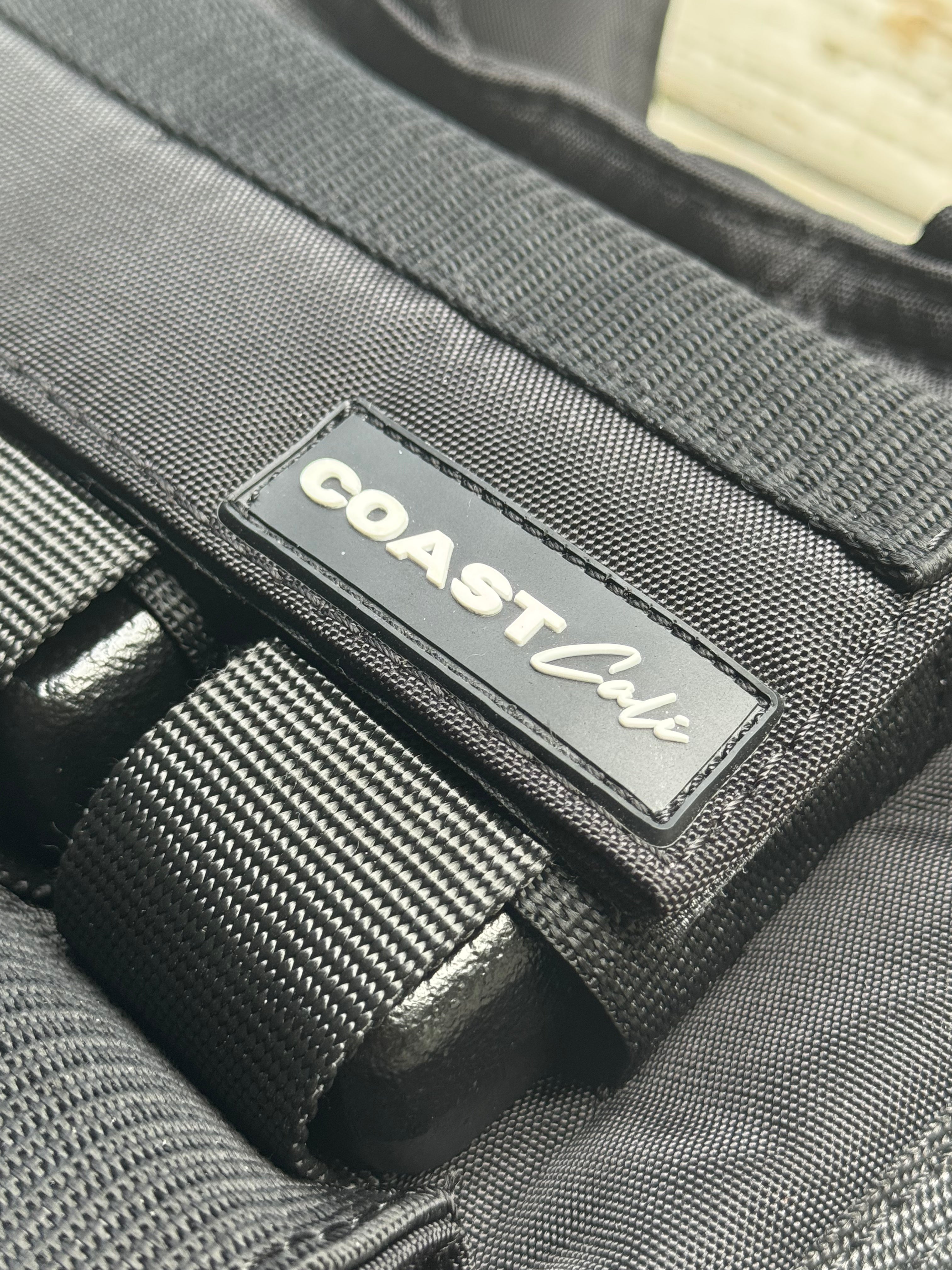 Close-up of a black weight vest with 'Coast cali' brand label.