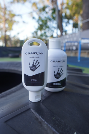 A close up of a 200ml & 50ml liquid chalk on an exercise tyre